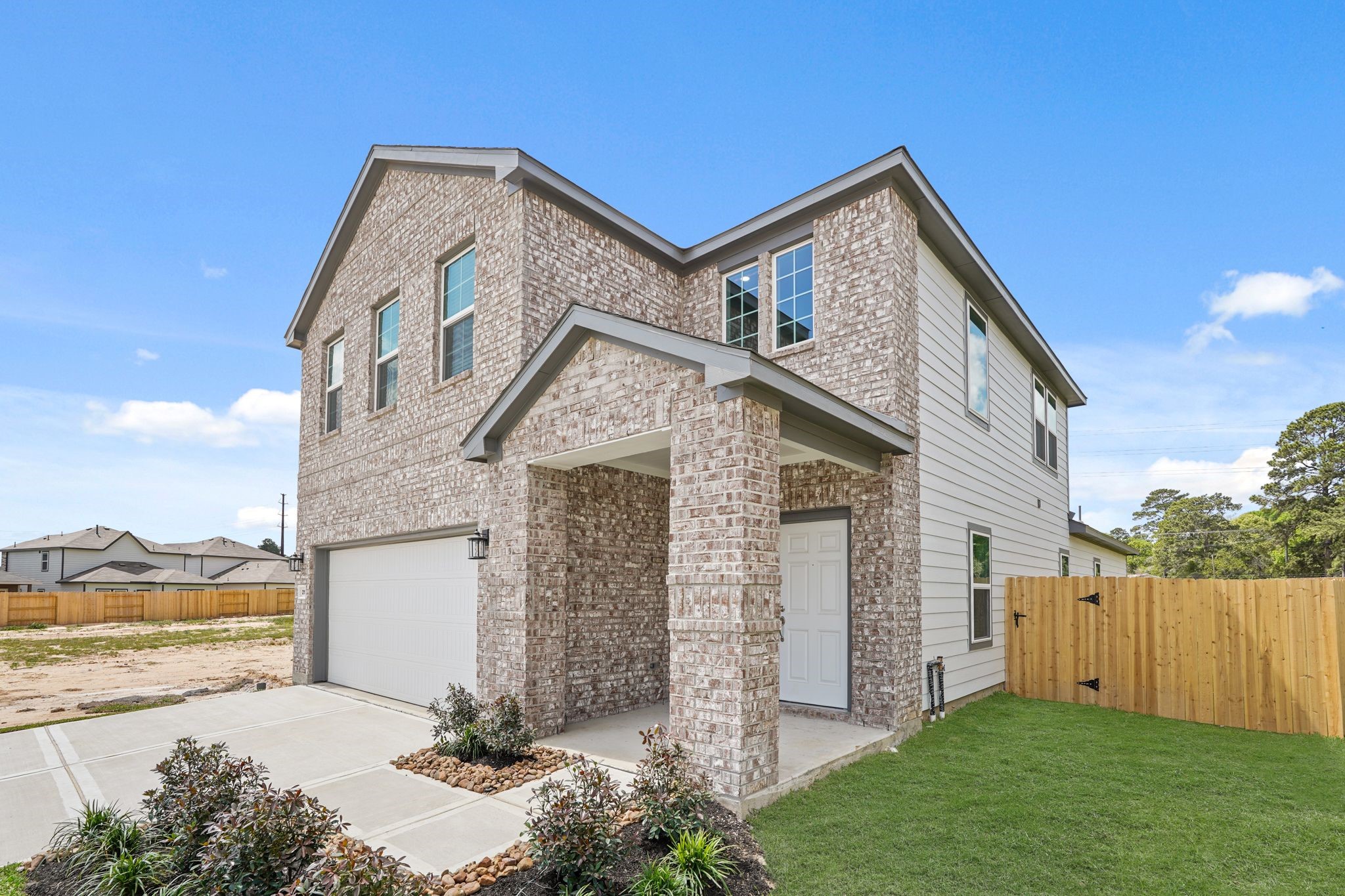 213 Spring Drive Hockley, TX 77447 - Photo 2 of 26 a front view of a house with garden