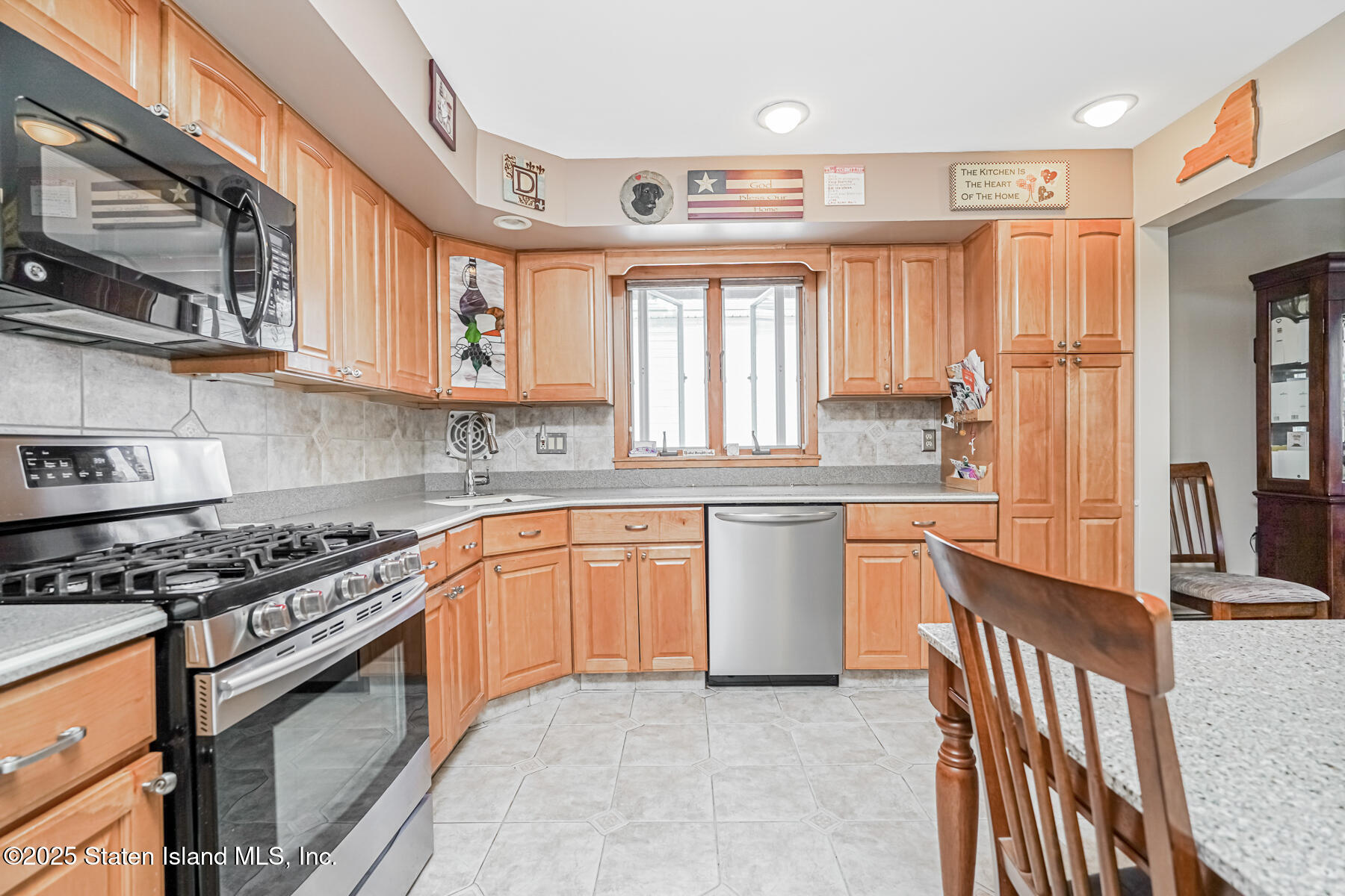 149 Rensselaer Avenue Staten Island, NY 10312 - Photo 14 of 33 a kitchen with stainless steel appliances granite countertop a stove a sink and a refrigerator