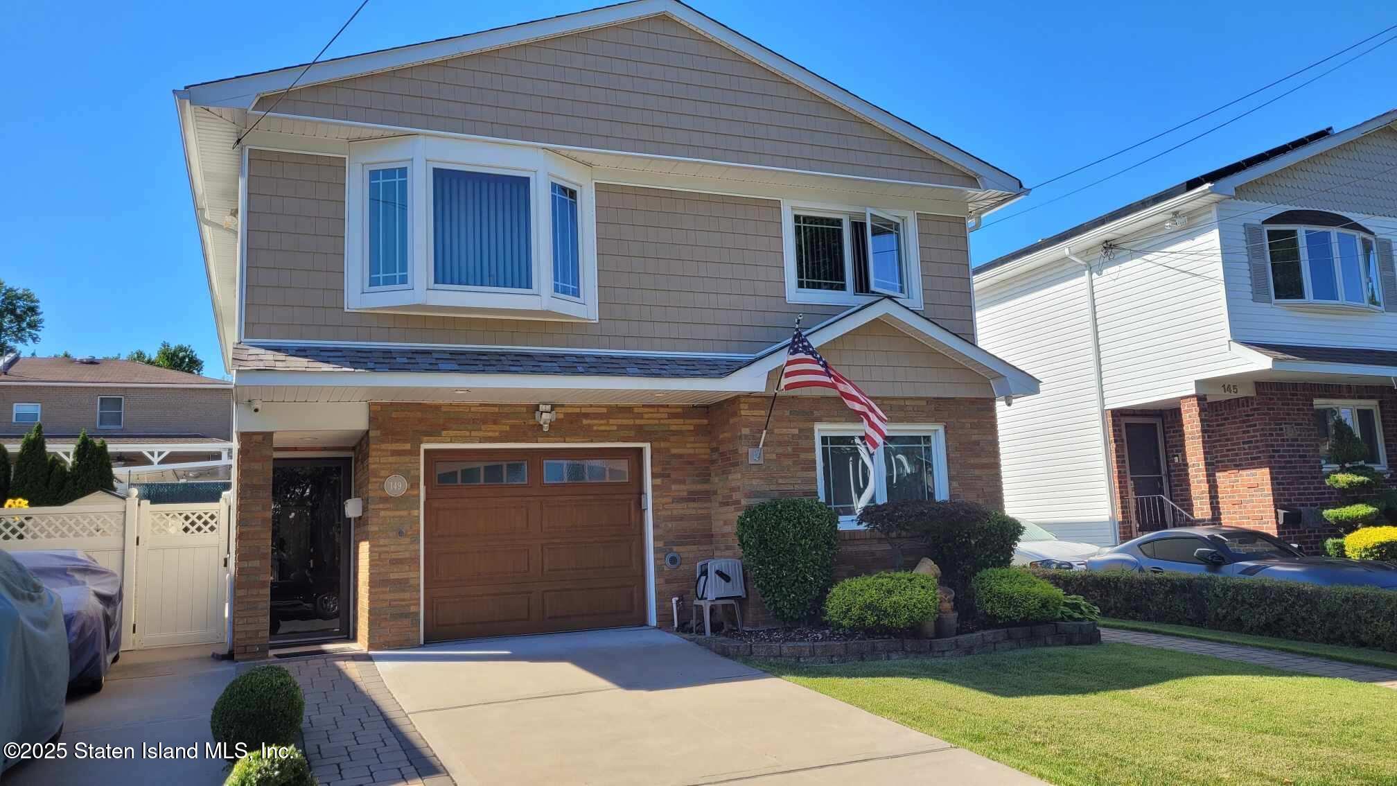 149 Rensselaer Avenue Staten Island, NY 10312 - Photo 2 of 33 a front view of a house with garden