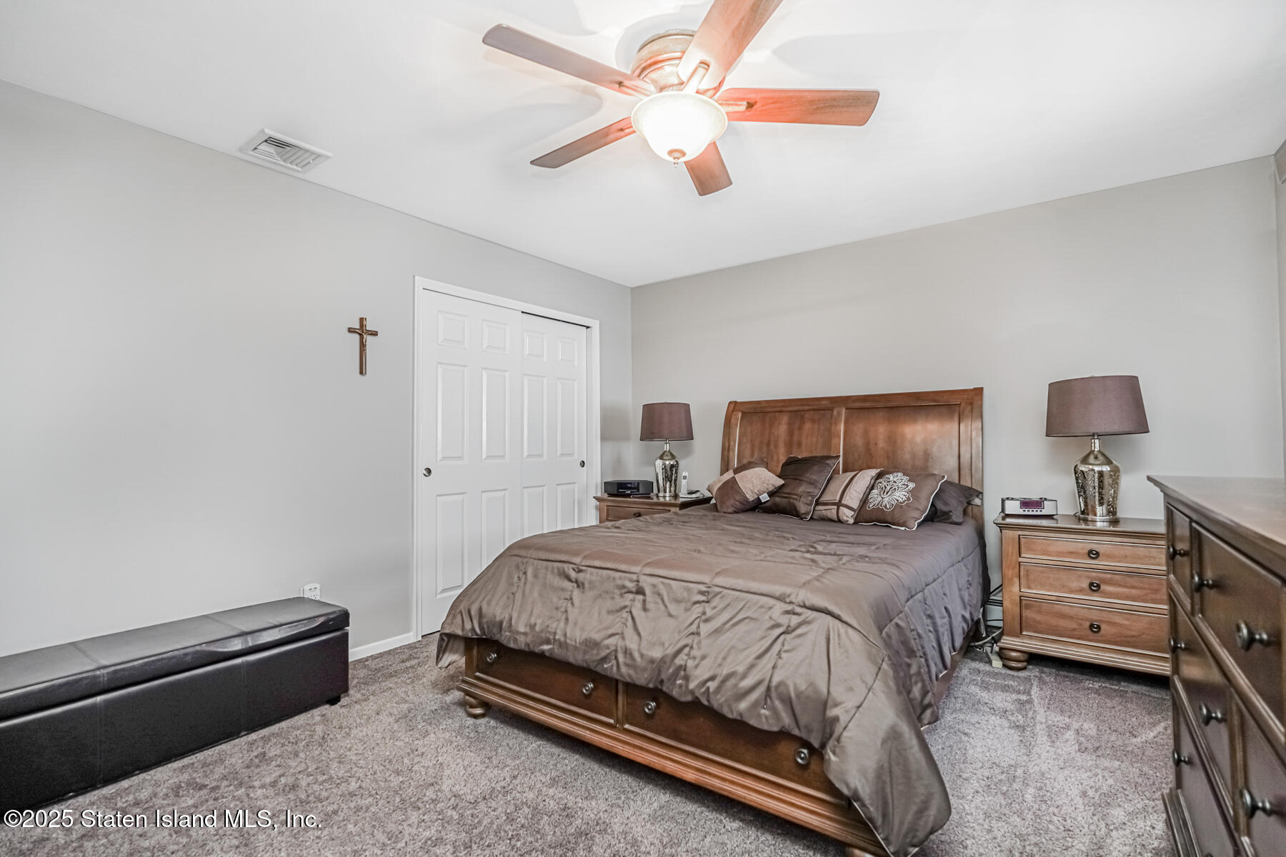 149 Rensselaer Avenue Staten Island, NY 10312 - Photo 21 of 33 a bedroom with a bed and a chandelier