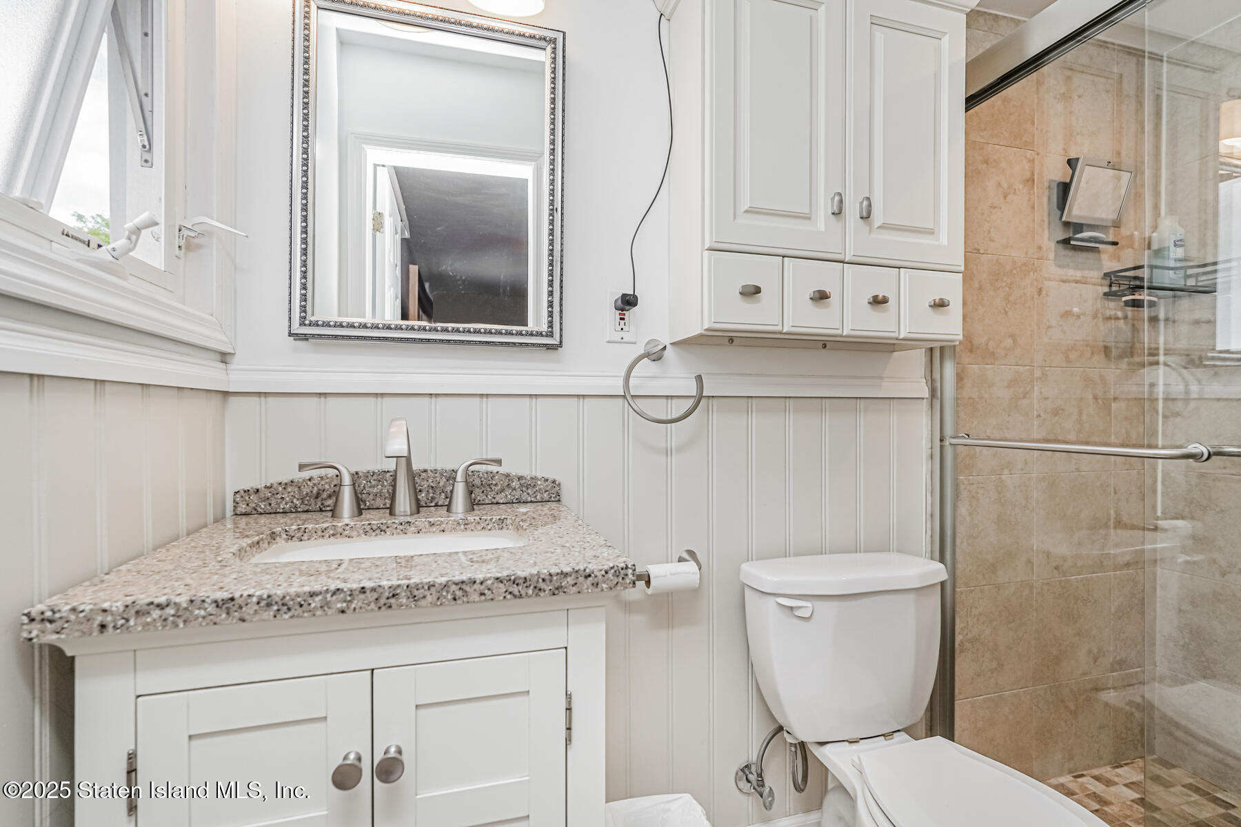 149 Rensselaer Avenue Staten Island, NY 10312 - Photo 22 of 33 a bathroom with a granite countertop toilet sink and mirror
