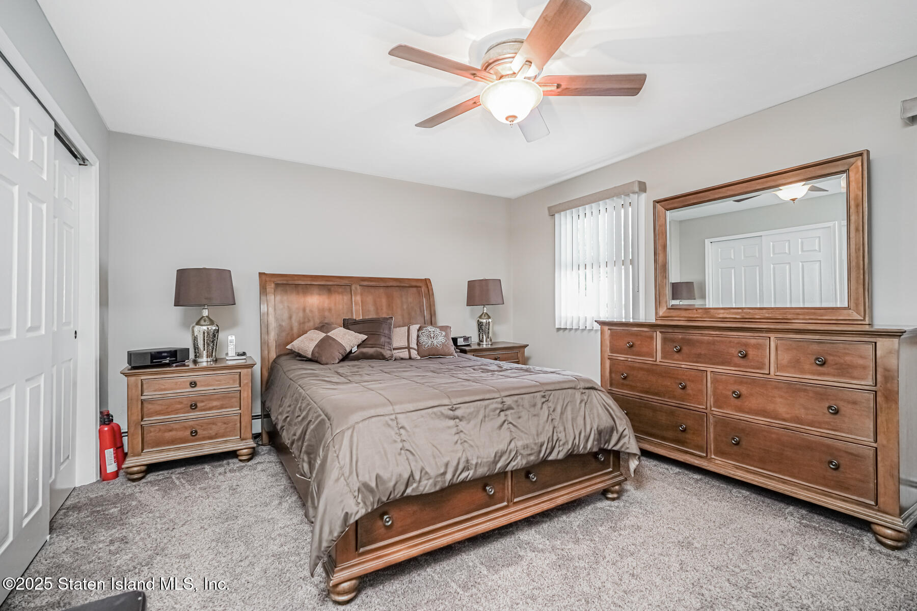 149 Rensselaer Avenue Staten Island, NY 10312 - Photo 23 of 33 a bedroom with a bed and a chandelier