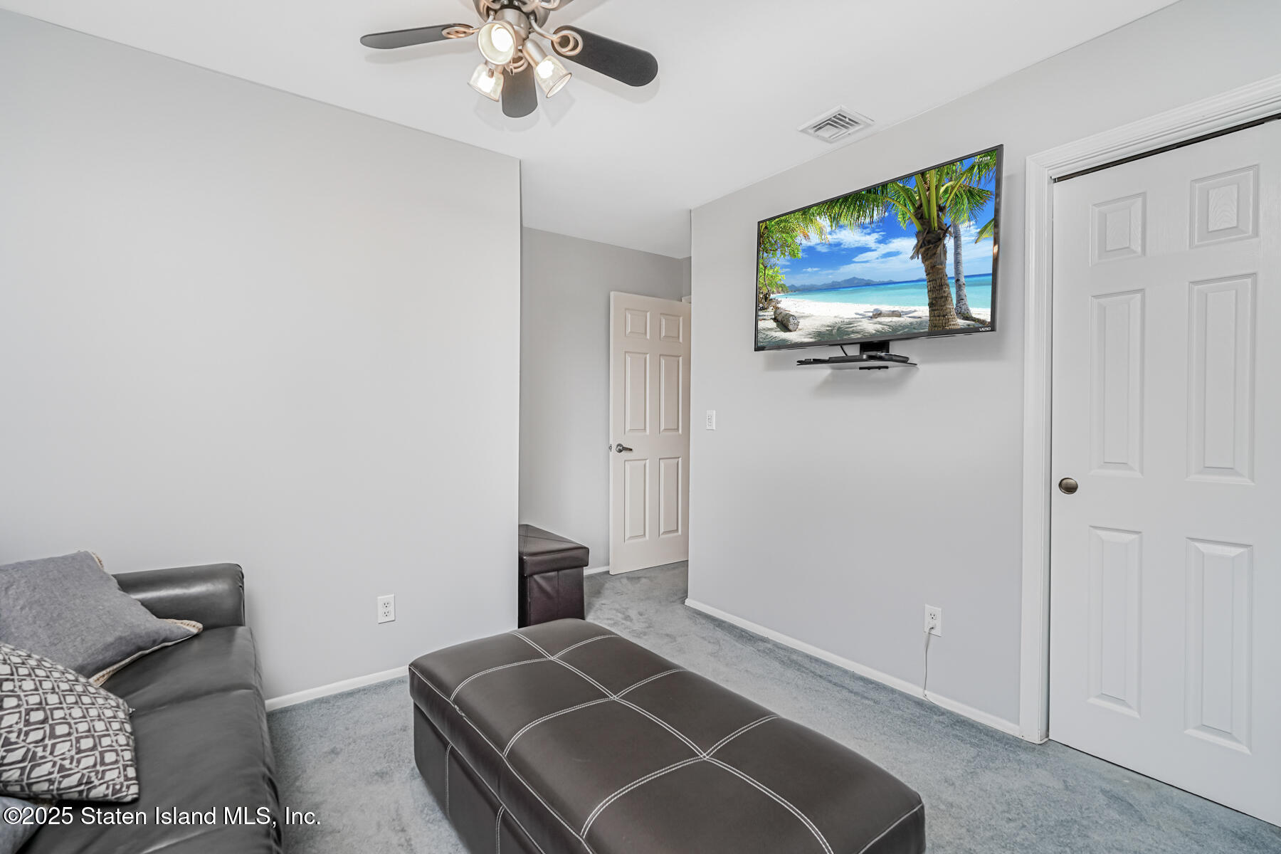 149 Rensselaer Avenue Staten Island, NY 10312 - Photo 27 of 33 a living room with furniture and a flat screen tv