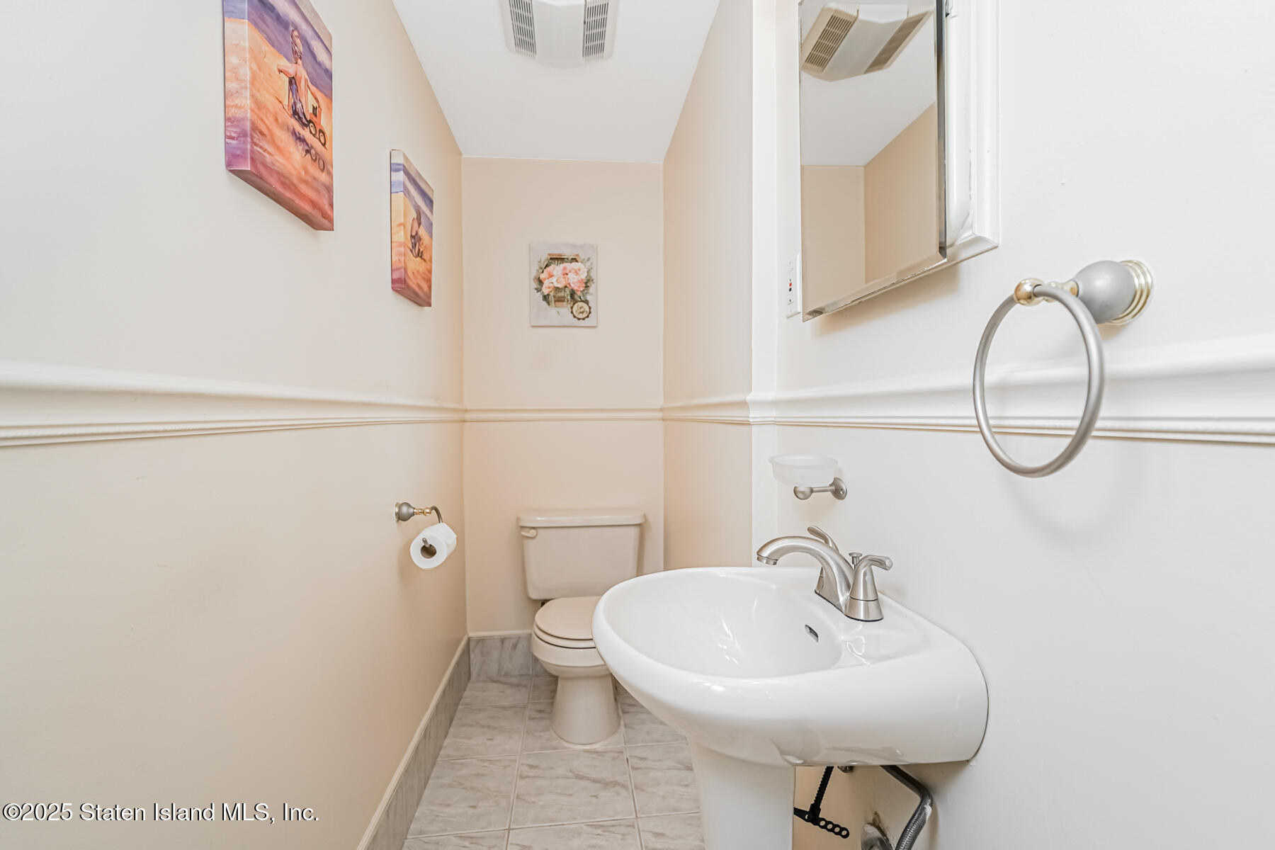 149 Rensselaer Avenue Staten Island, NY 10312 - Photo 6 of 33 a bathroom with a sink a toilet and mirror