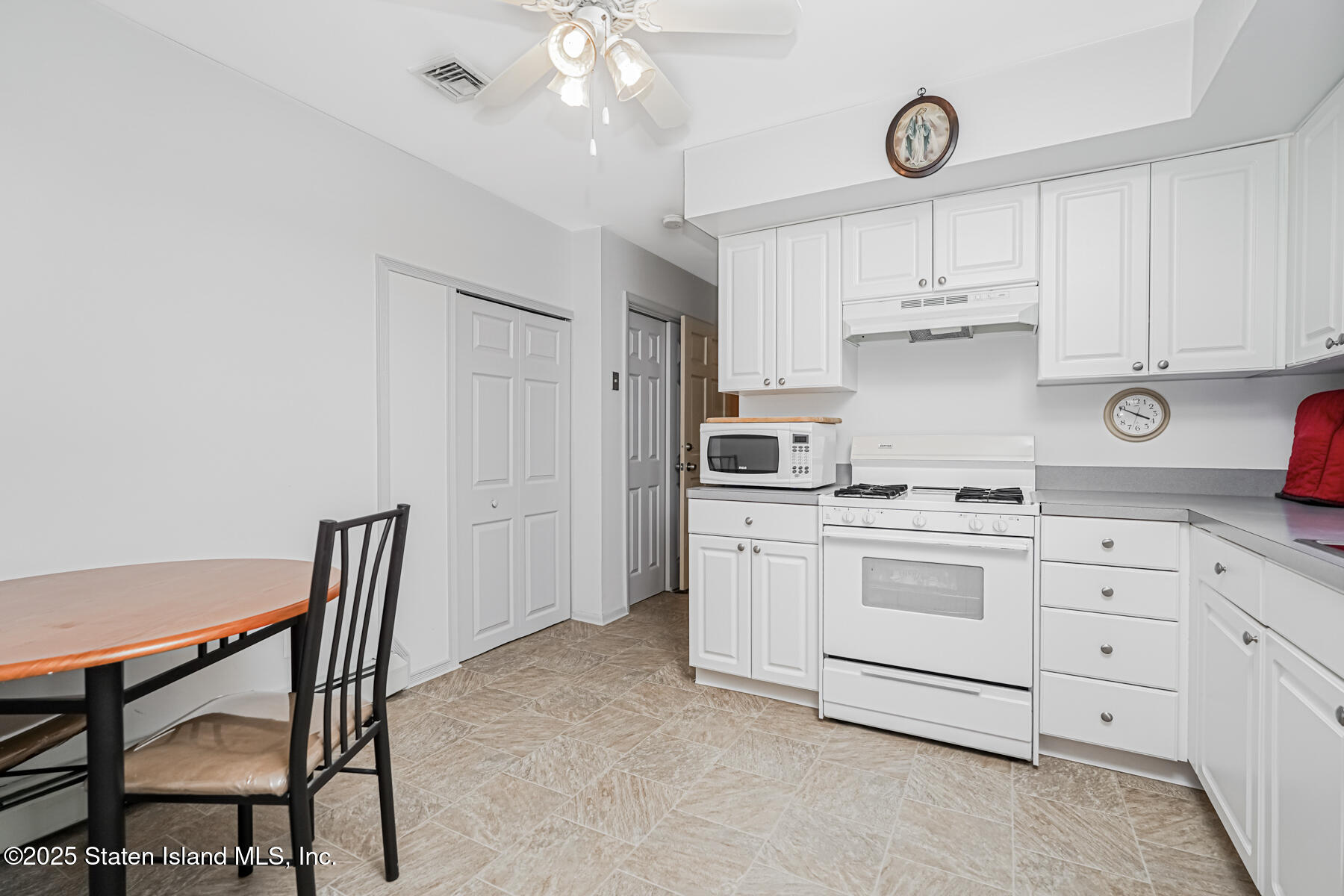 149 Rensselaer Avenue Staten Island, NY 10312 - Photo 8 of 33 a kitchen with cabinets appliances cabinets and furniture