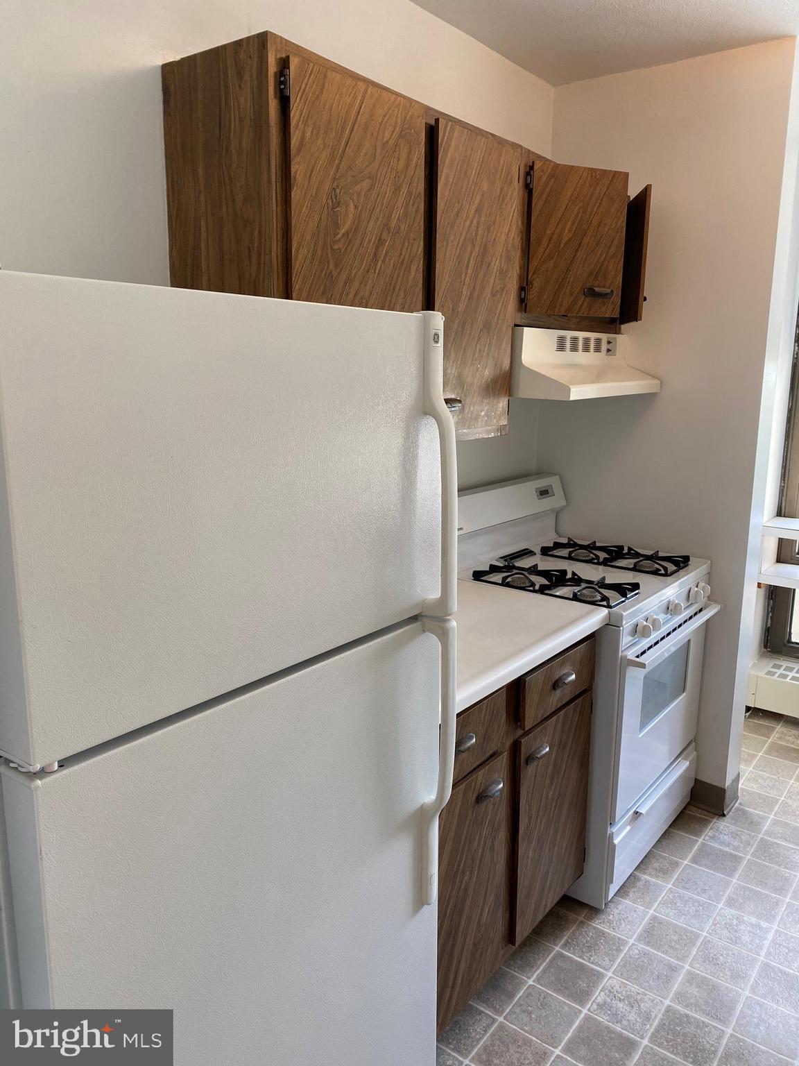 200 Locust Street, Unit 4GN Philadelphia, PA 19106 - Photo 2 of 13 a kitchen with stainless steel appliances a refrigerator and a stove top oven