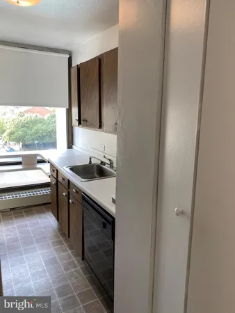 a kitchen with a sink and a refrigerator