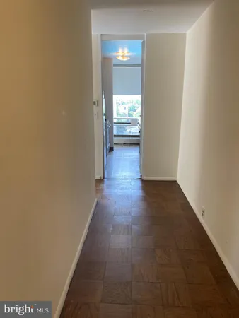 a view of a hallway with wooden floor