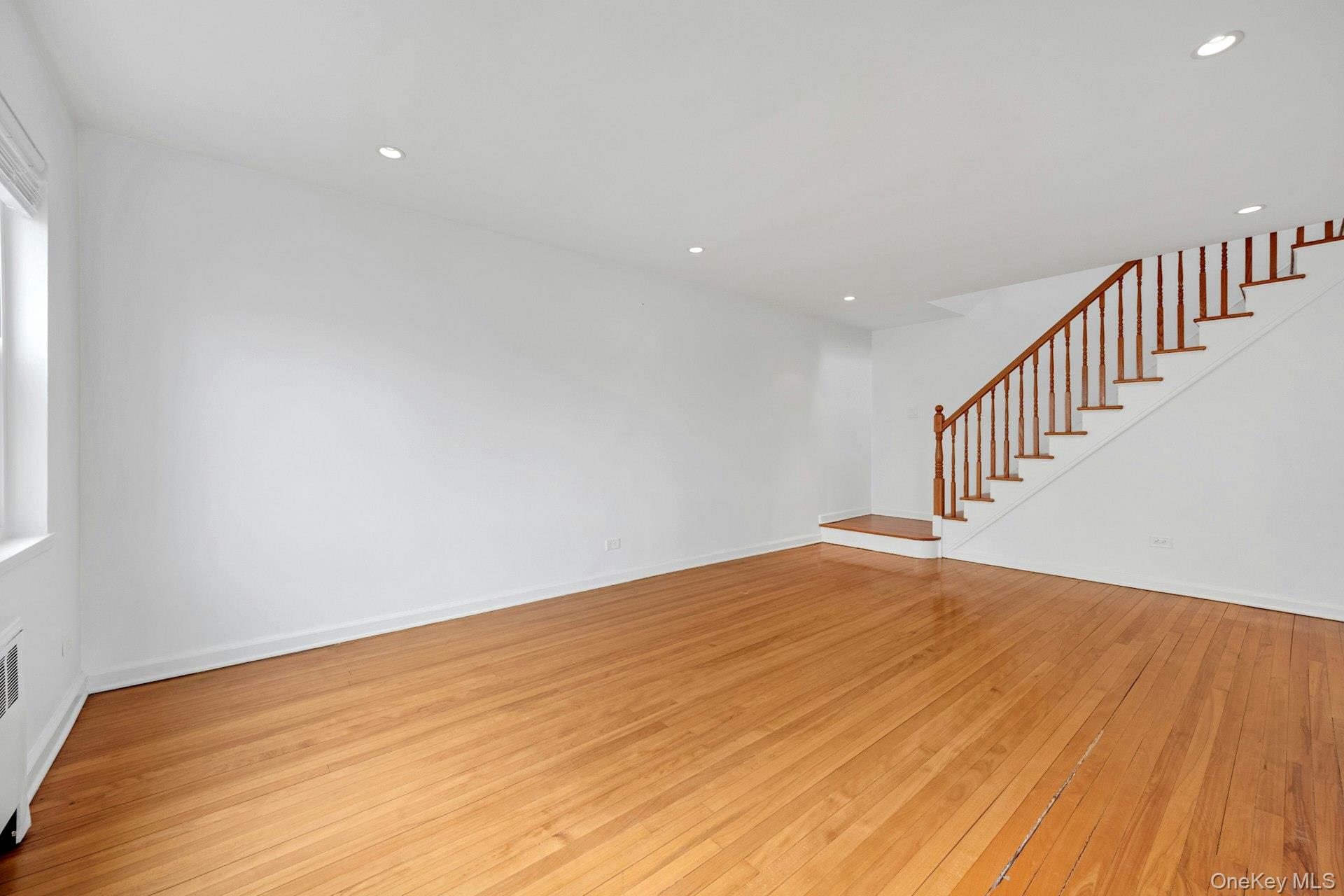 184 Purchase Street, Unit 12 Rye, NY 10580 - Photo 11 of 33 a view of an empty room with wooden floor and stairs