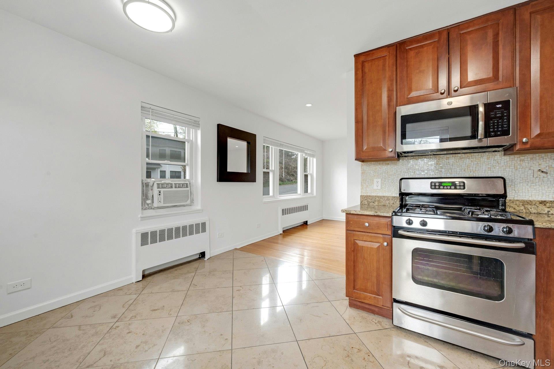 184 Purchase Street, Unit 12 Rye, NY 10580 - Photo 14 of 33 a kitchen with stainless steel appliances granite countertop a stove microwave and sink