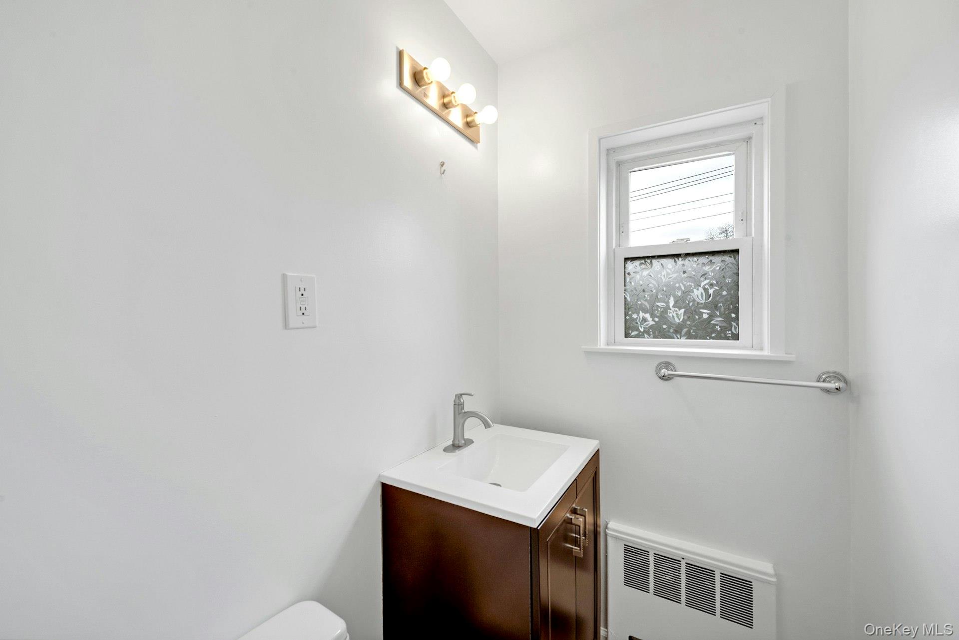184 Purchase Street, Unit 12 Rye, NY 10580 - Photo 17 of 33 a bathroom with a sink a mirror and a window
