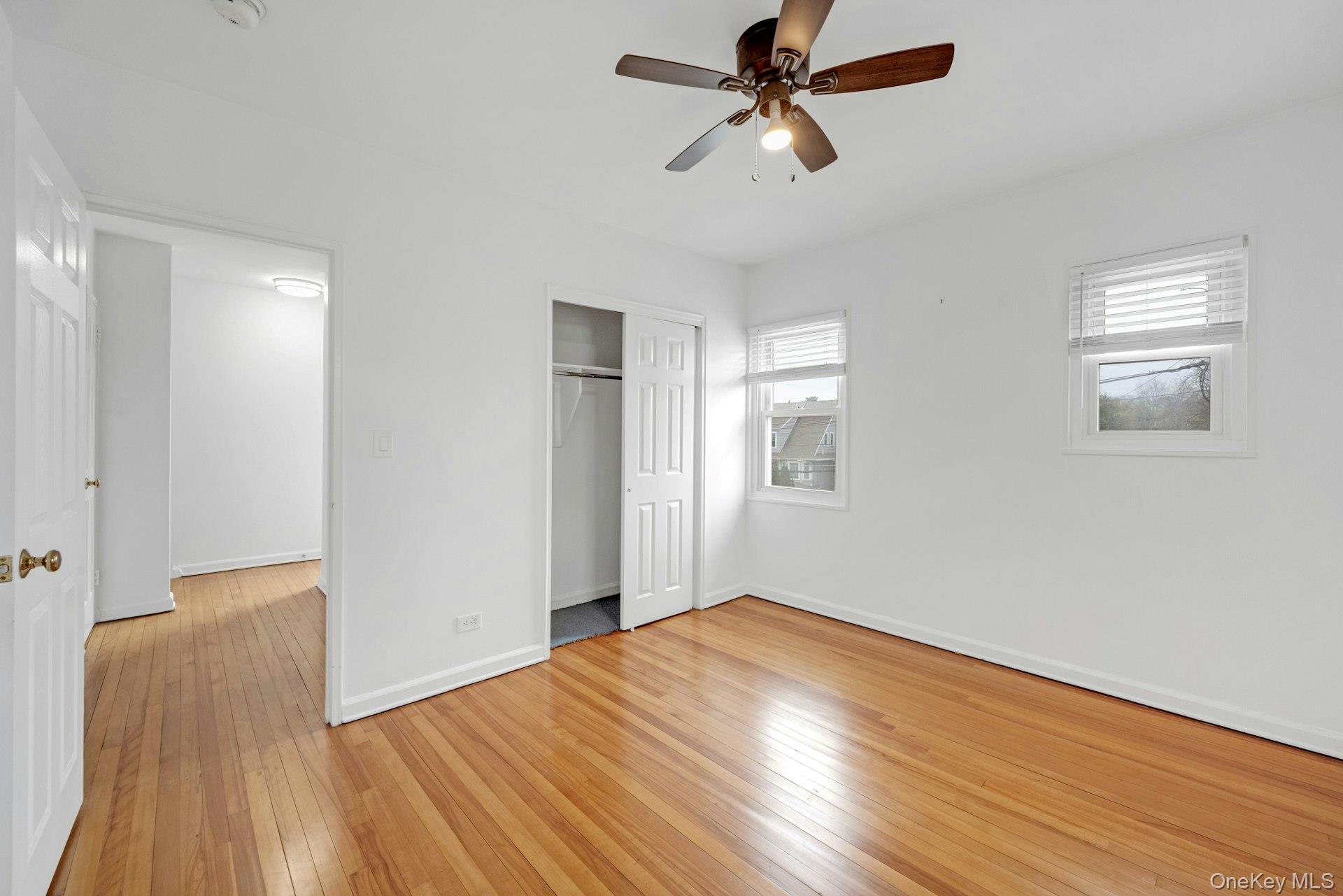 184 Purchase Street, Unit 12 Rye, NY 10580 - Photo 22 of 33 a view of empty room with wooden floor and fan