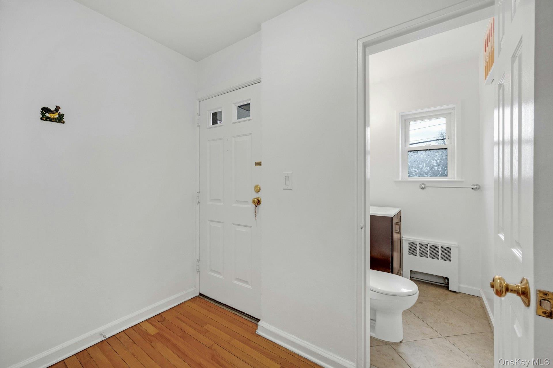 184 Purchase Street, Unit 12 Rye, NY 10580 - Photo 6 of 33 a white toilet sitting next to a bathroom sink and vanity