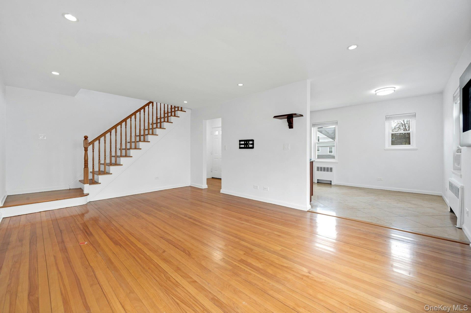 184 Purchase Street, Unit 12 Rye, NY 10580 - Photo 10 of 33 a view of an empty room with wooden floor and stairs