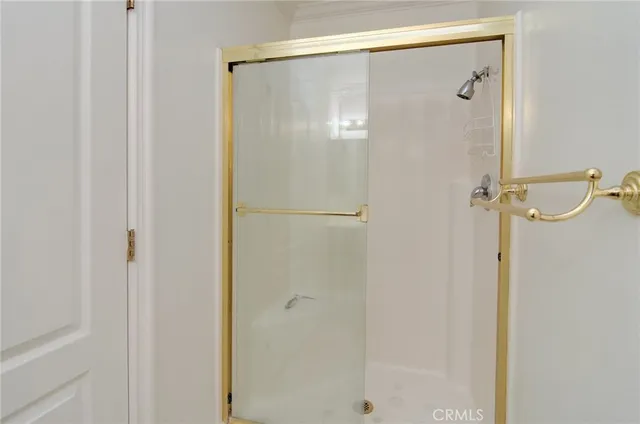 a bathroom with a glass shower door