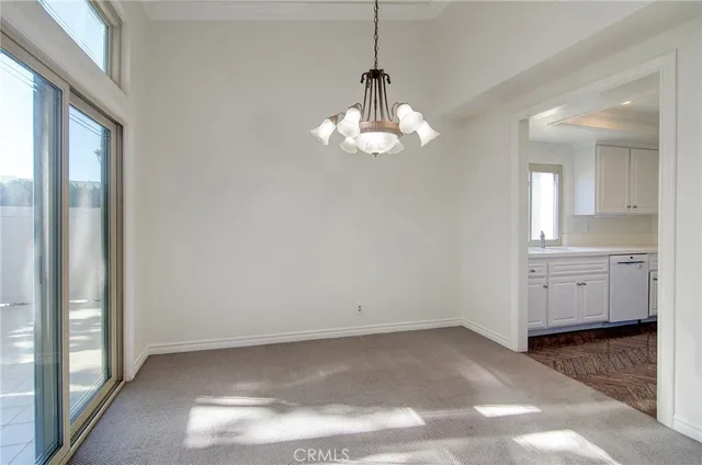a view of a chandelier fan and entryway