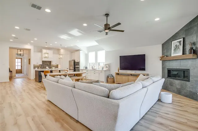 a living room with furniture kitchen view and a fireplace