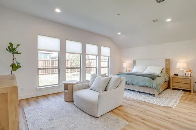 a spacious bedroom with a large bed and a couch