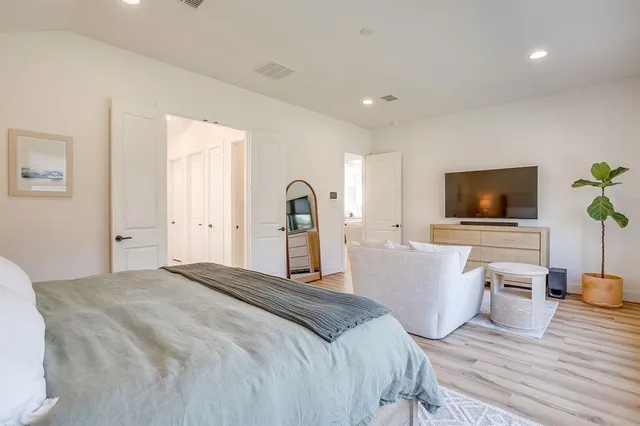 a bedroom with a bed and a flat screen tv