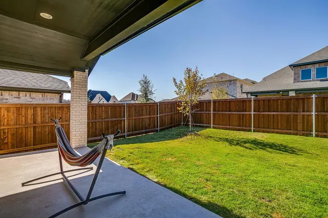 a view of a backyard with a garden and entertaining space