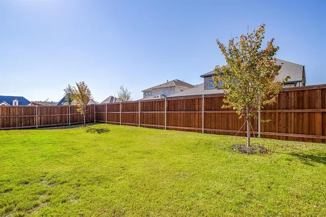 an aerial view of residential houses with outdoor space and ocean view