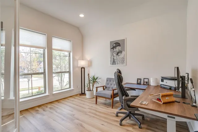 a view of a workspace with furniture and a window
