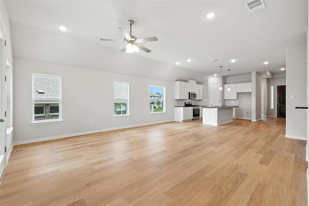 530 Red Barn Drive Van Alstyne, TX 75495 - Photo 12 of 40 Unfurnished living room with ceiling fan, recessed lighting, and light wood finished floors