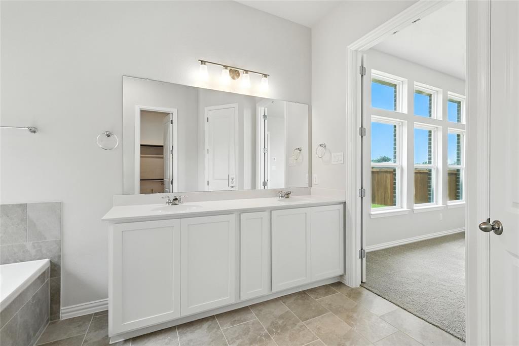 530 Red Barn Drive Van Alstyne, TX 75495 - Photo 16 of 40 Bathroom with double vanity and baseboards