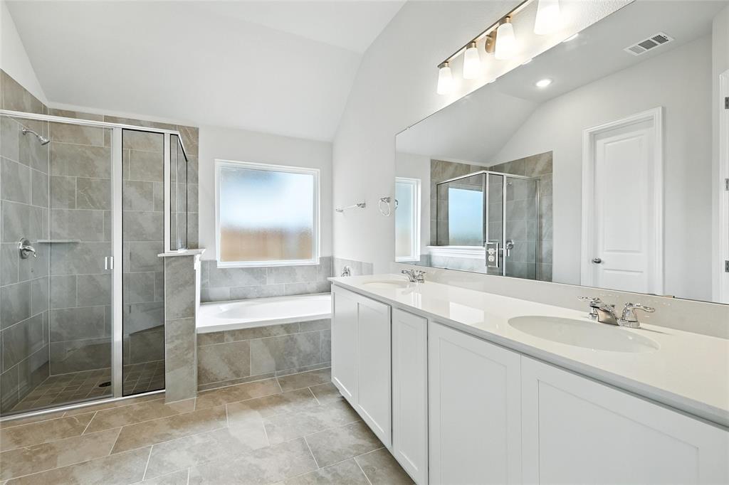 530 Red Barn Drive Van Alstyne, TX 75495 - Photo 17 of 40 Full bathroom with vaulted ceiling, a stall shower, double vanity, and a bath