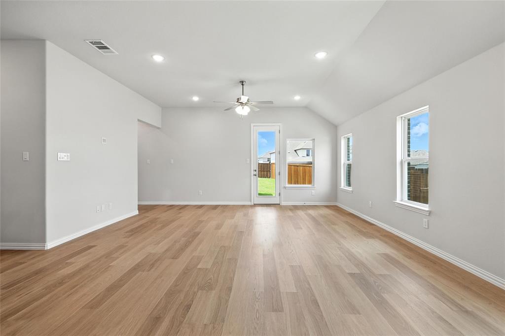 530 Red Barn Drive Van Alstyne, TX 75495 - Photo 9 of 40 Unfurnished living room with a ceiling fan, vaulted ceiling, light wood-style floors, and recessed lighting