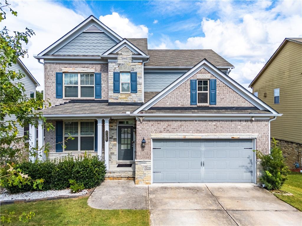 2375 Matlin Way Buford, GA 30519 - Photo 1 of 58 a front view of a house with garden