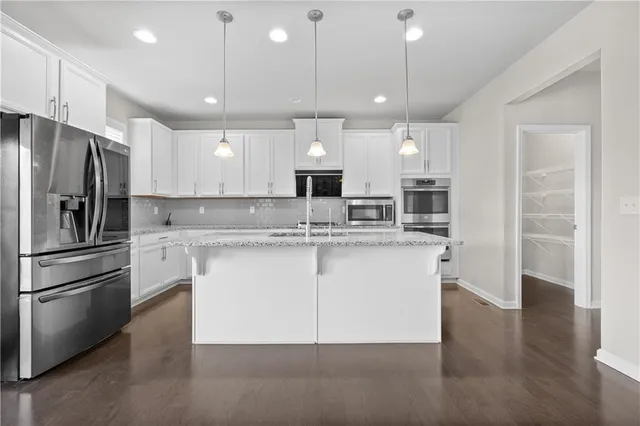 a view of kitchen with wooden floor and windows