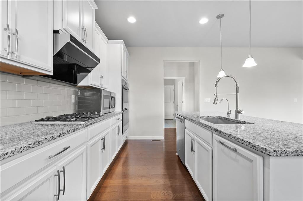2375 Matlin Way Buford, GA 30519 - Photo 16 of 58 a kitchen with stainless steel appliances granite countertop a sink and a stove