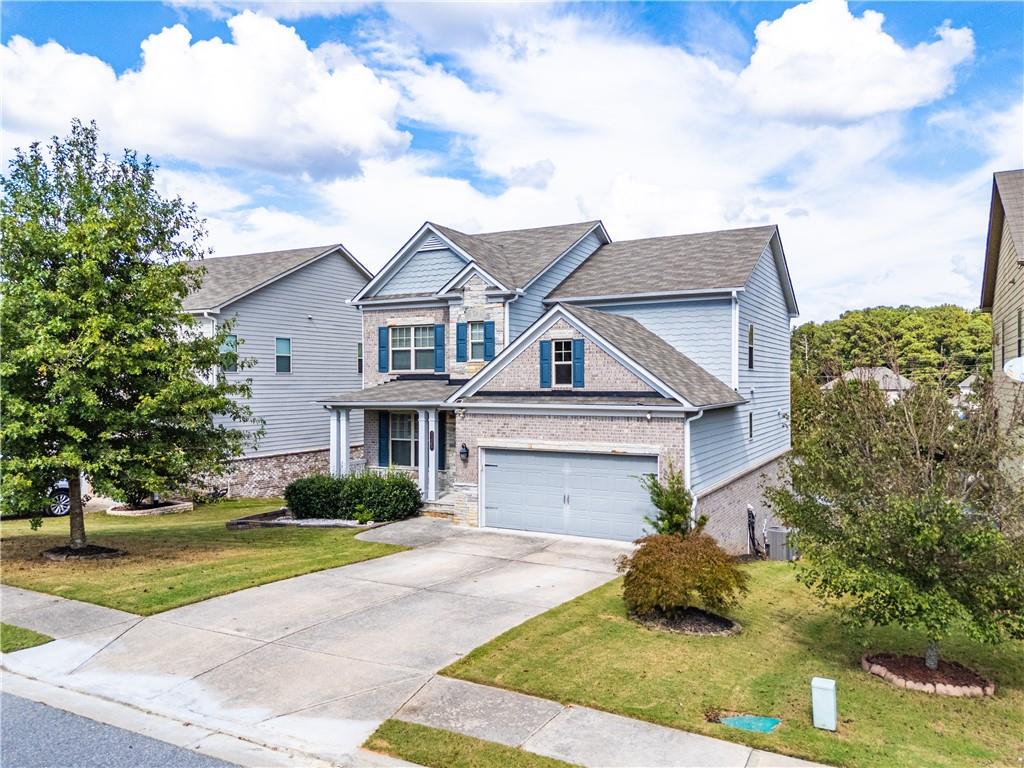 2375 Matlin Way Buford, GA 30519 - Photo 2 of 58 a front view of a house with a garden