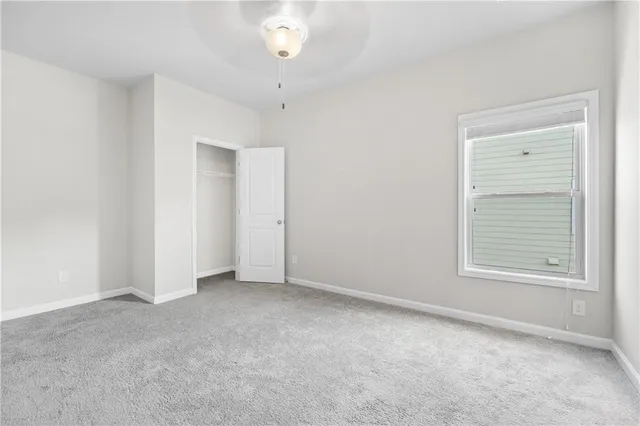 an empty room with windows and outdoor view