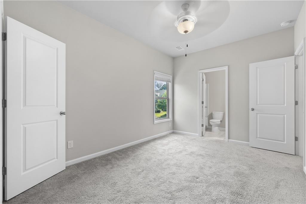 2375 Matlin Way Buford, GA 30519 - Photo 28 of 58 an empty room with windows and ceiling fan