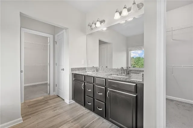 wooden floor with white walls and stairs