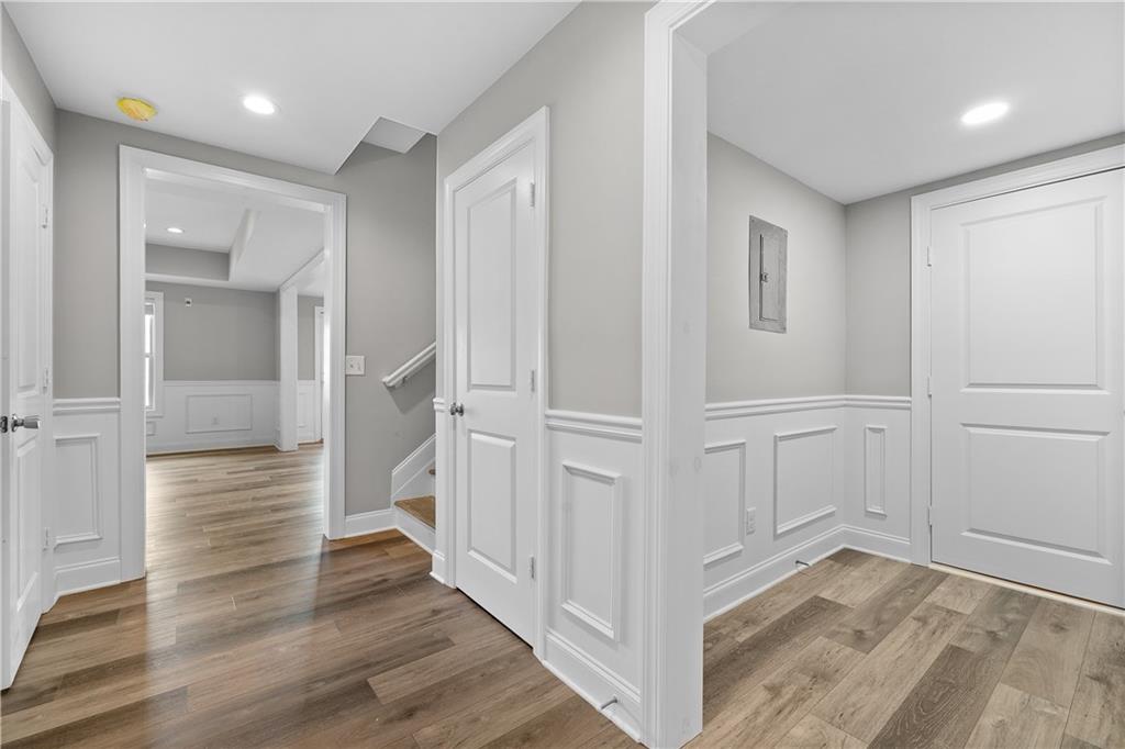 2375 Matlin Way Buford, GA 30519 - Photo 40 of 58 wooden floor with white walls and stairs