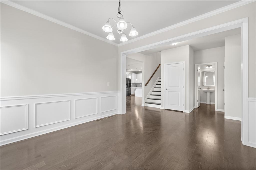 2375 Matlin Way Buford, GA 30519 - Photo 4 of 58 a view of an empty room with wooden floor and stairs