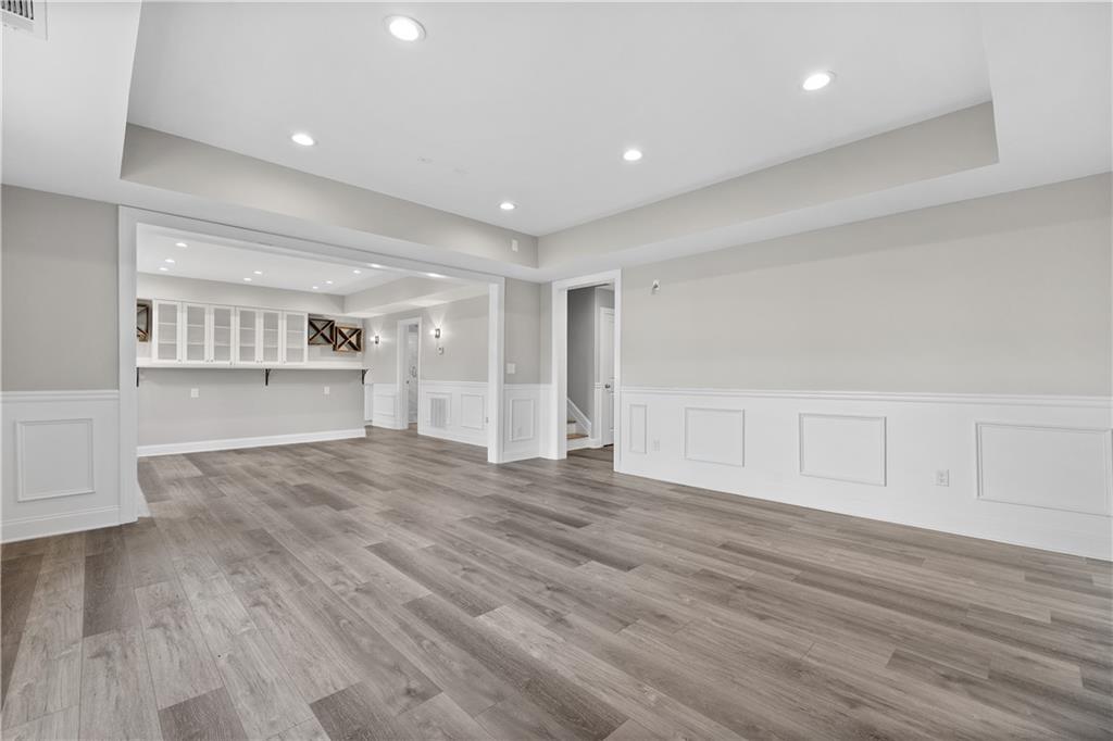 2375 Matlin Way Buford, GA 30519 - Photo 45 of 58 a view of empty room with wooden floor and kitchen