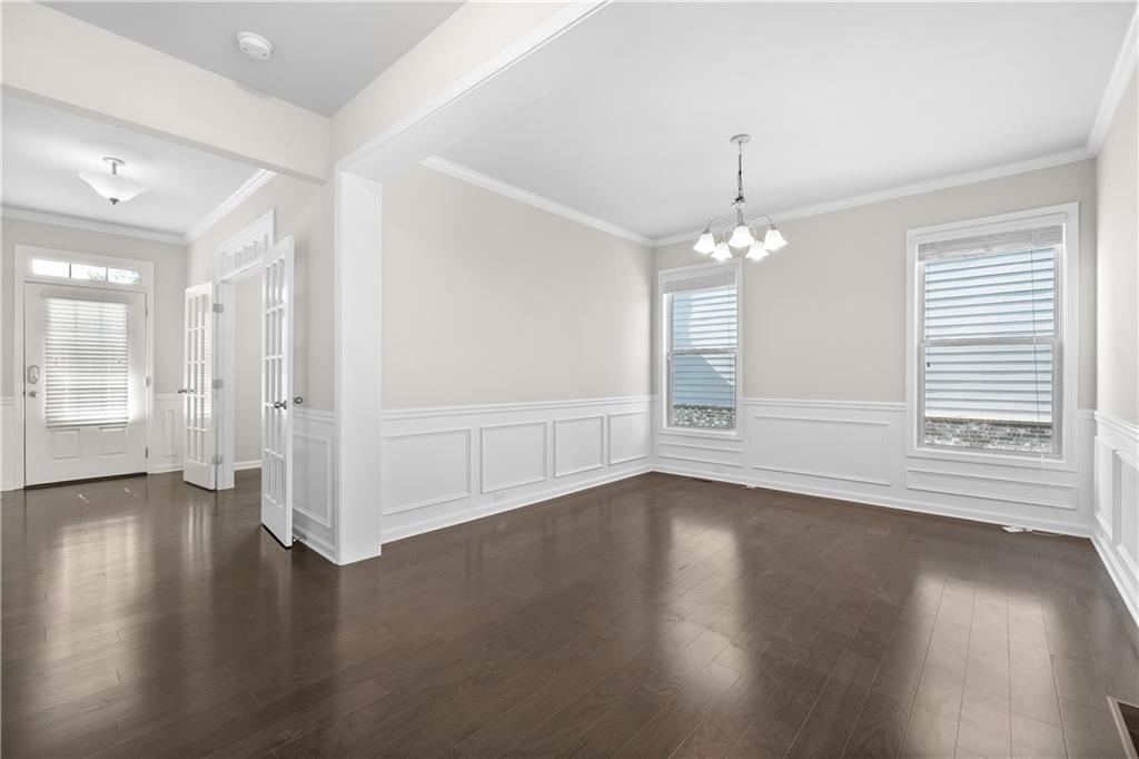 2375 Matlin Way Buford, GA 30519 - Photo 6 of 58 an empty room with wooden floor and windows