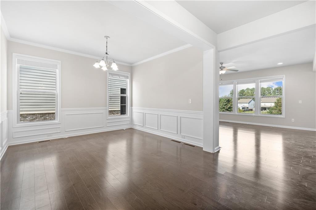 2375 Matlin Way Buford, GA 30519 - Photo 8 of 58 an empty room with wooden floor and windows