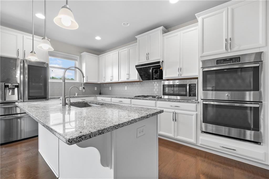 2375 Matlin Way Buford, GA 30519 - Photo 10 of 58 a kitchen with stainless steel appliances granite countertop a sink stove and refrigerator