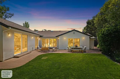 a view of a house with a backyard porch and sitting area