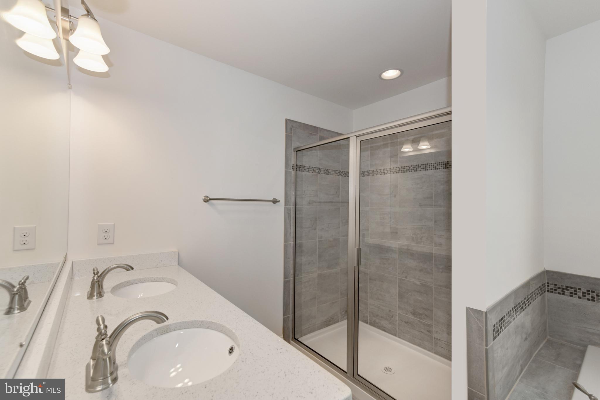400 Rederick Lane, Unit 2 Middletown, DE 19709 - Photo 15 of 23 a bathroom with a sink vanity mirror and shower