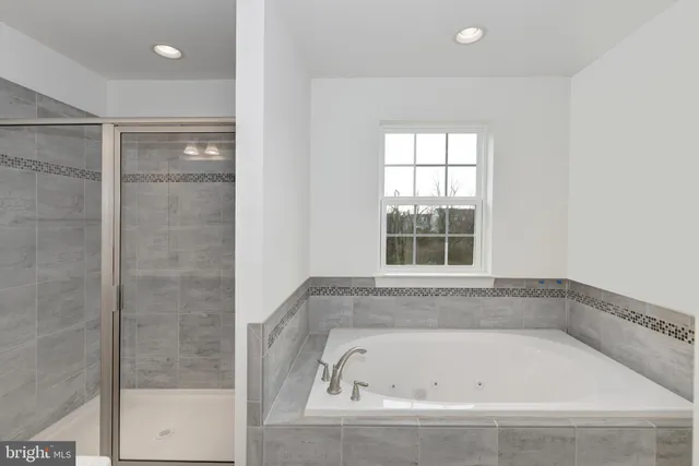 a bathroom with a bathtub and shower