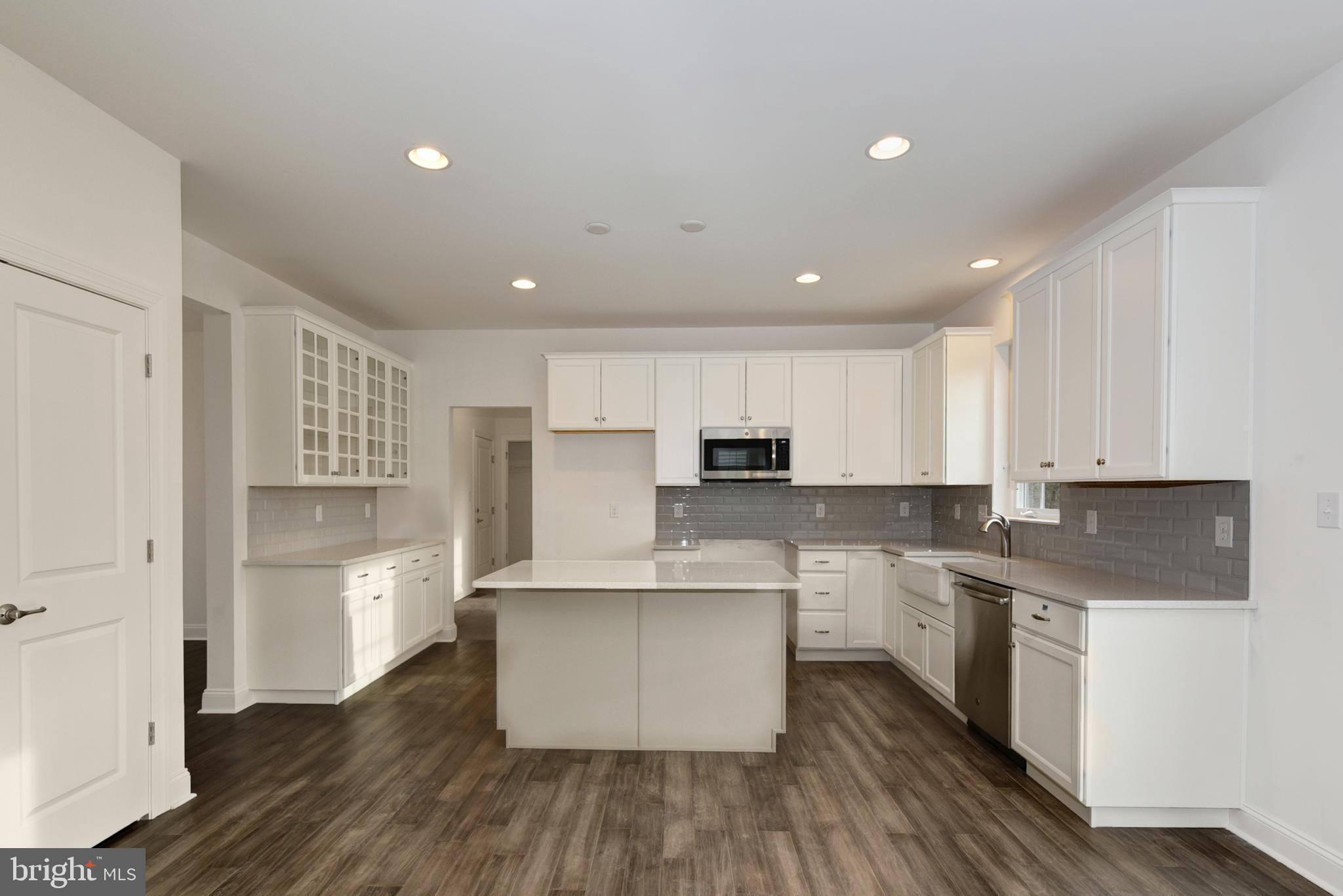 400 Rederick Lane, Unit 2 Middletown, DE 19709 - Photo 19 of 23 a kitchen with stainless steel appliances granite countertop a white cabinets and wooden floor