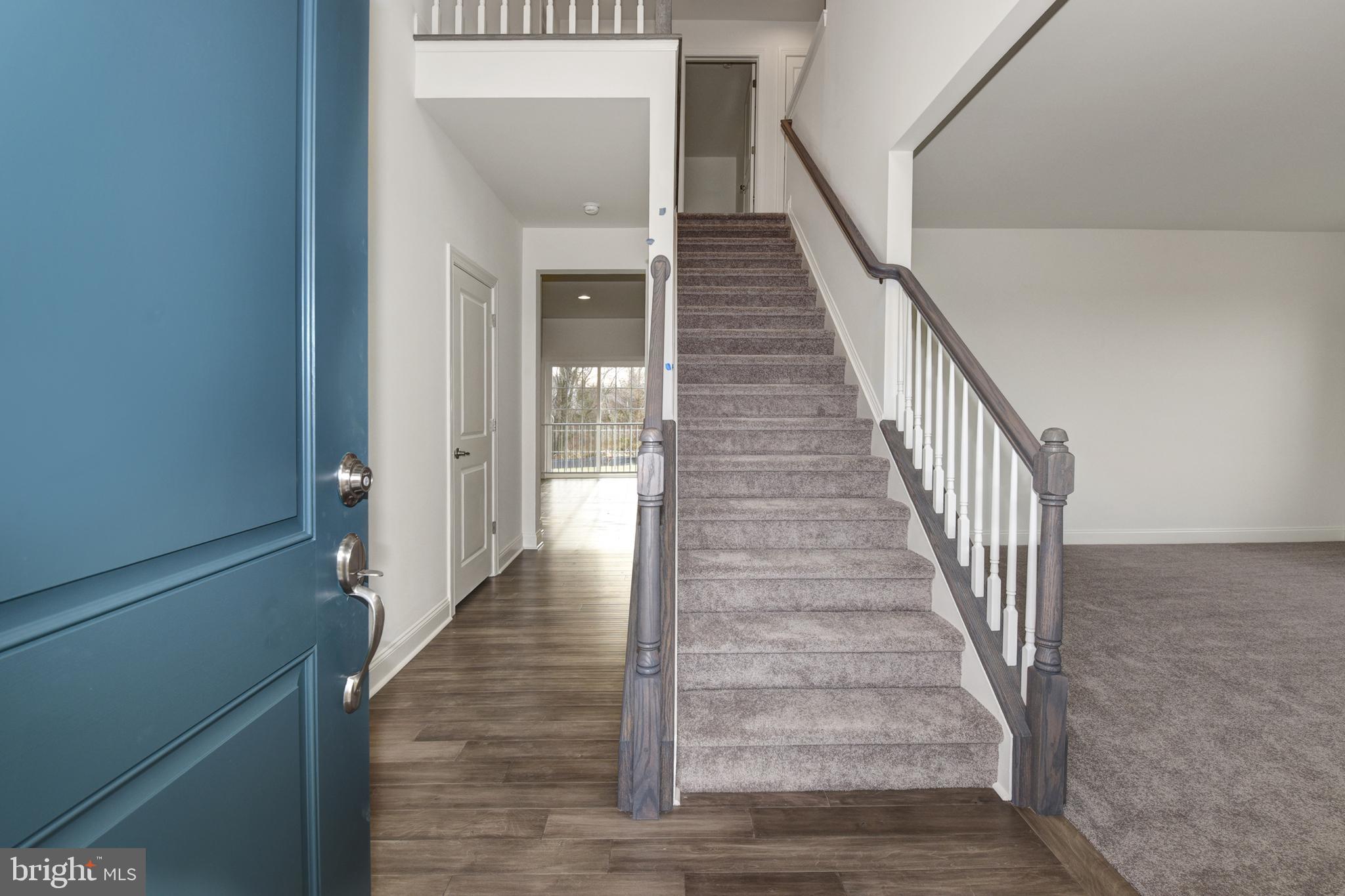 400 Rederick Lane, Unit 2 Middletown, DE 19709 - Photo 2 of 23 a view of a hallway with wooden floor and staircase