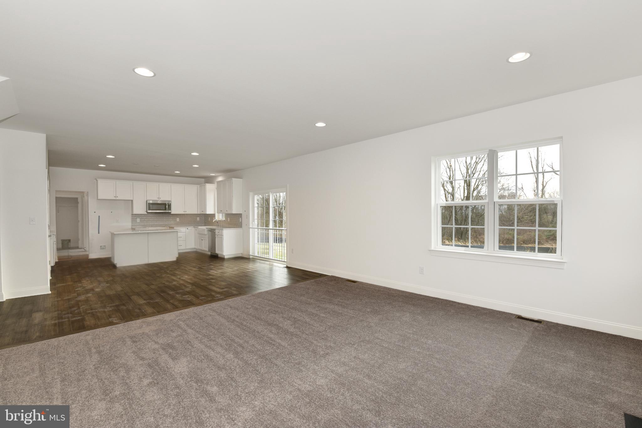 400 Rederick Lane, Unit 2 Middletown, DE 19709 - Photo 10 of 23 an empty room with a kitchen and windows