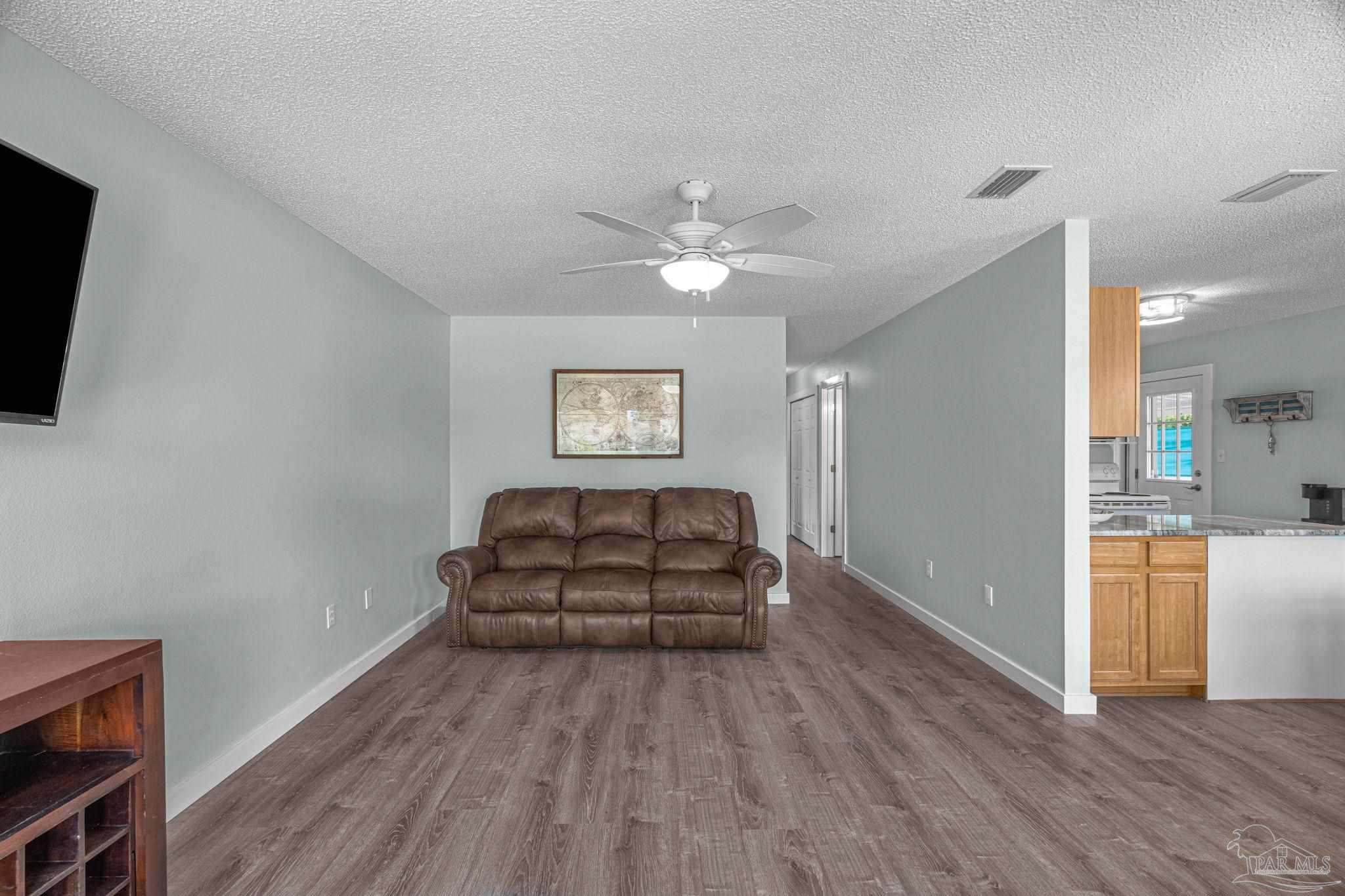 5301 Viking Road Pensacola, FL 32507 - Photo 20 of 35 a living room with furniture and a flat screen tv